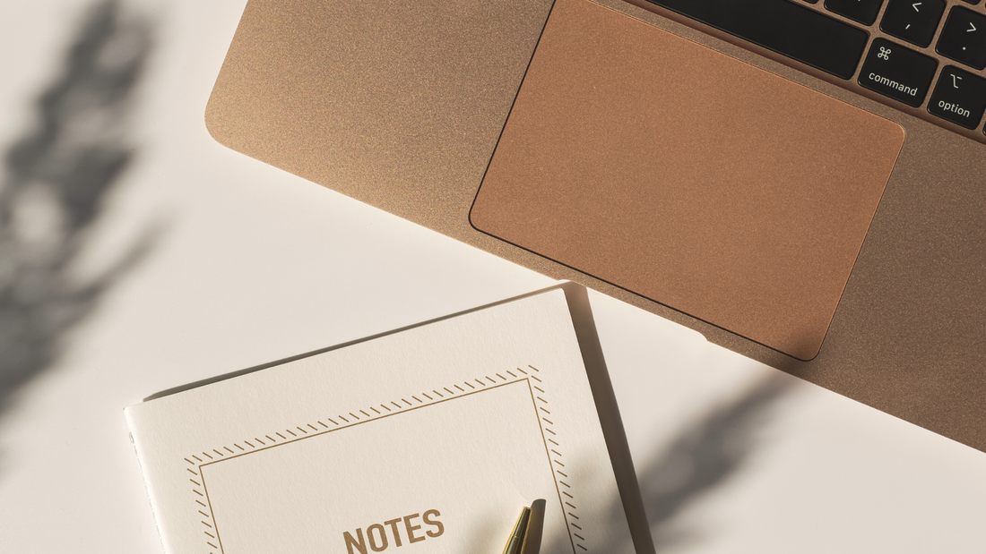 Laptop and notes pad for planning